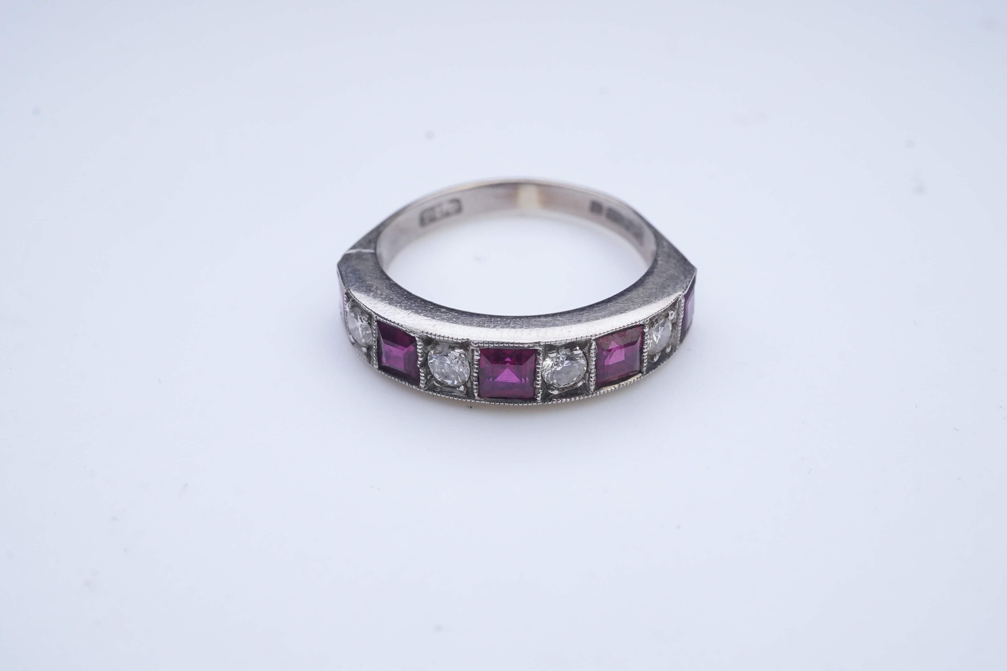 A ruby and diamond half eternity ring